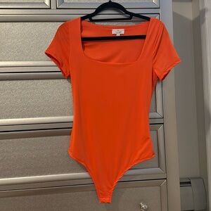 Neon orange body suit